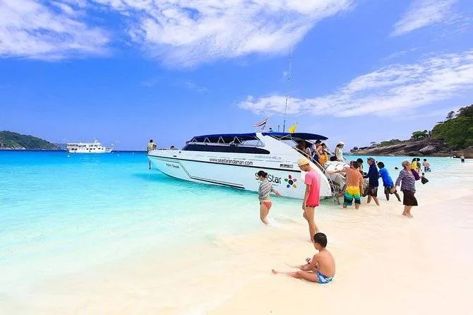 people getting off boat at the beach