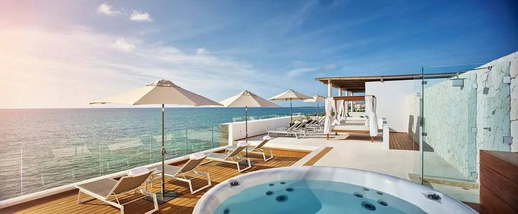 private wooden patio with lounge chair and pool