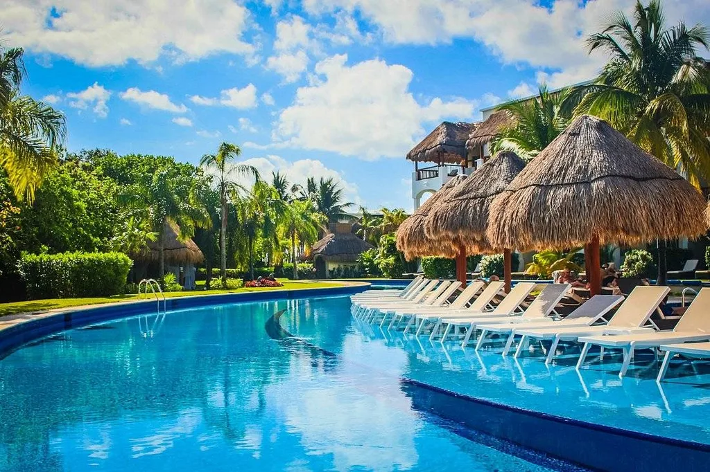 curved resort pool with lounge chairs