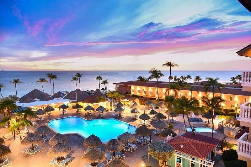 tropical resort with lighted pool at night