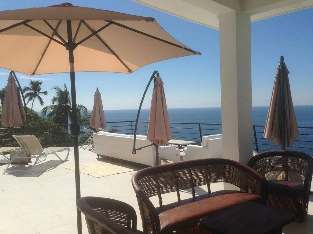 lounge chairs and umbrella on patio
