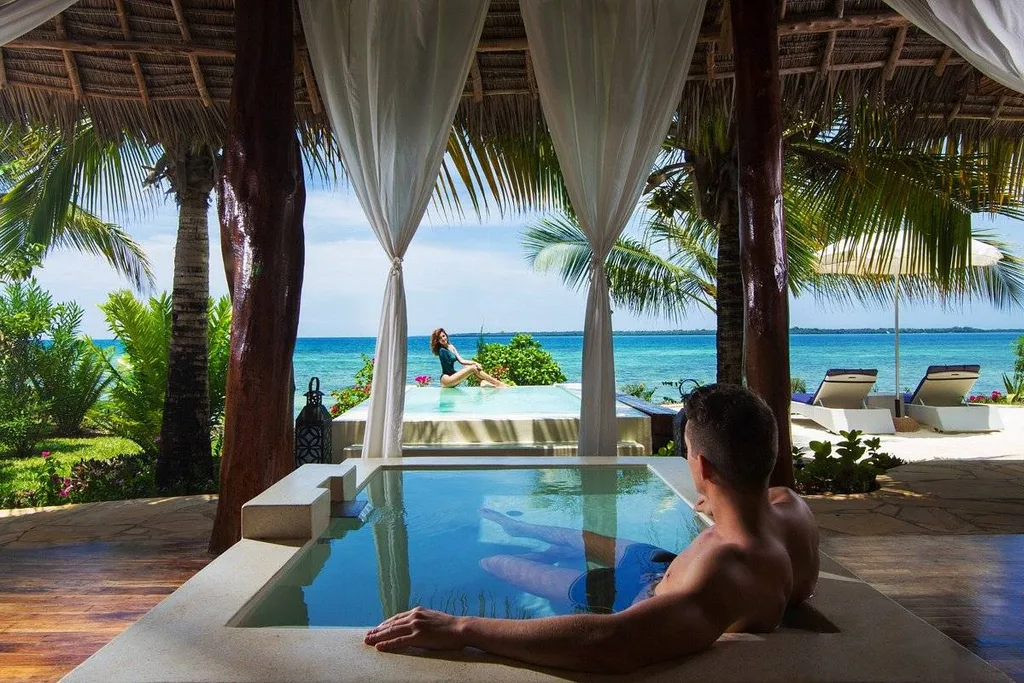 man sitting in pool at the beach