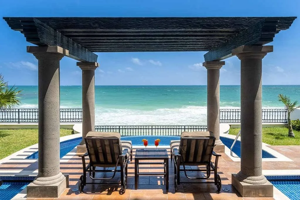 two chairs under pergola with private pool at the beach