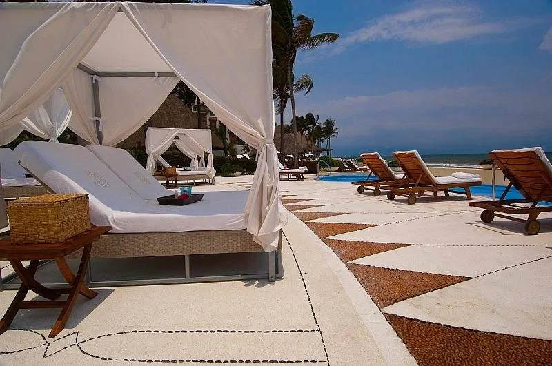 covered lounge chairs on cement patio