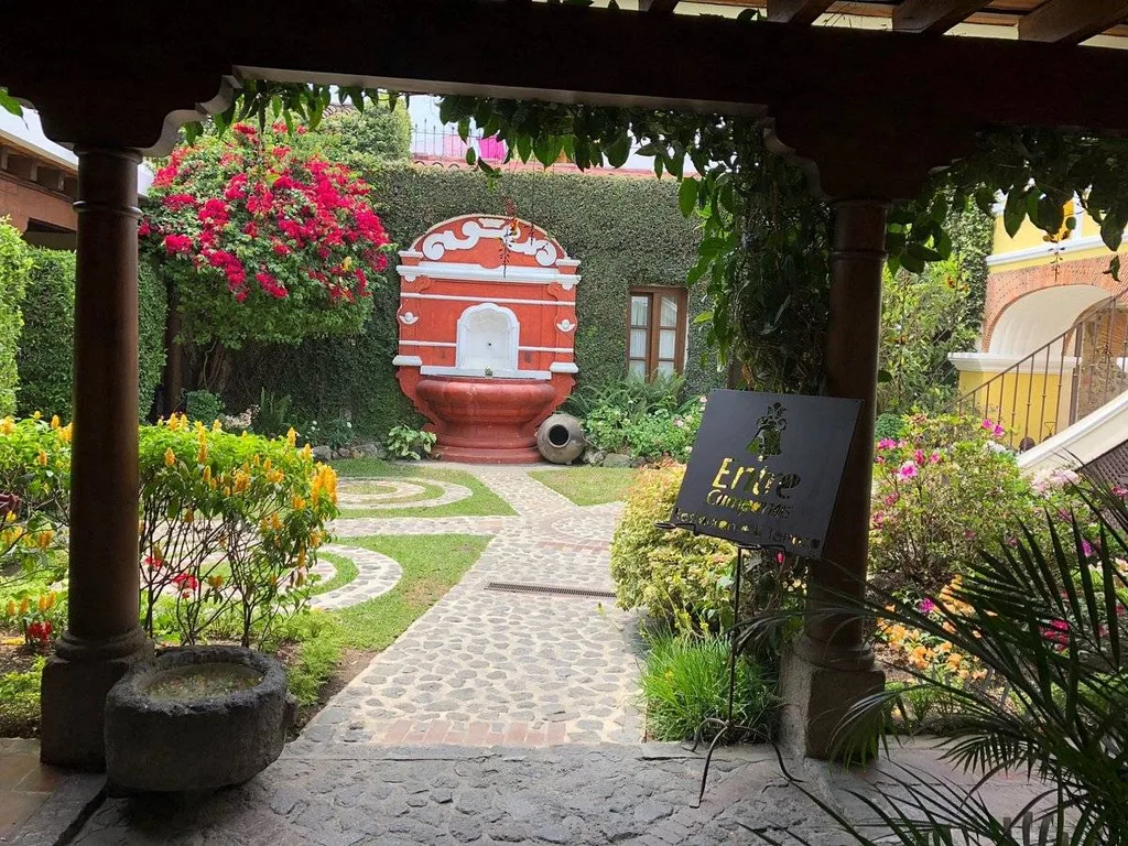 courtyard with stone pavers and red fountain