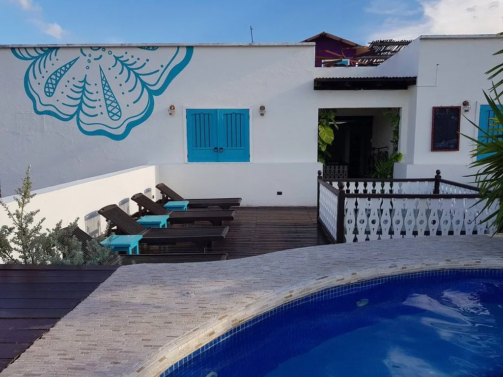 white building with 3 lounge chairs on patio