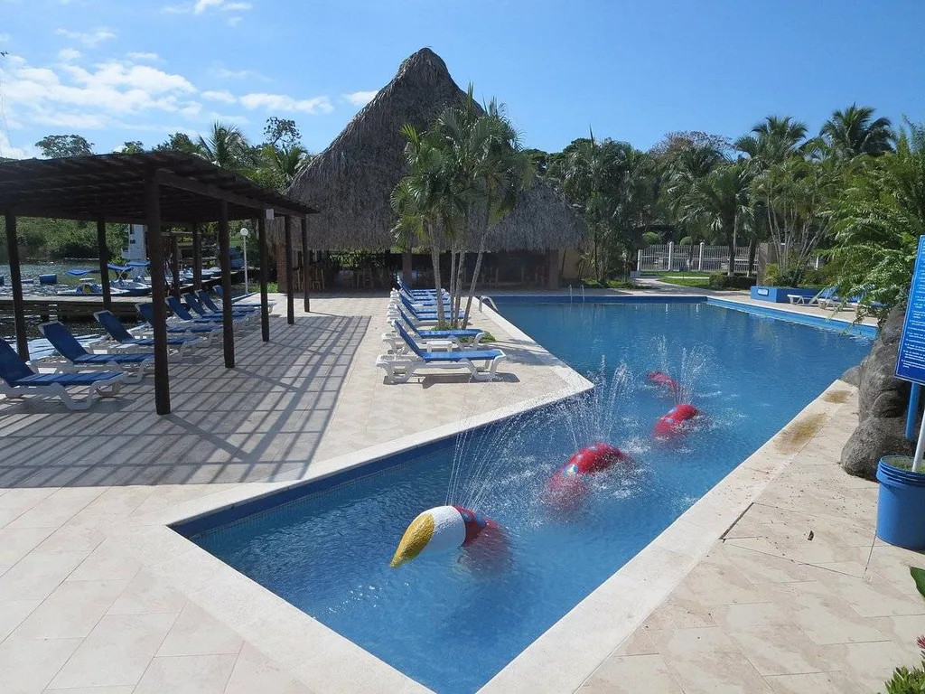 irregular shaped resort pool with pyramid building in back