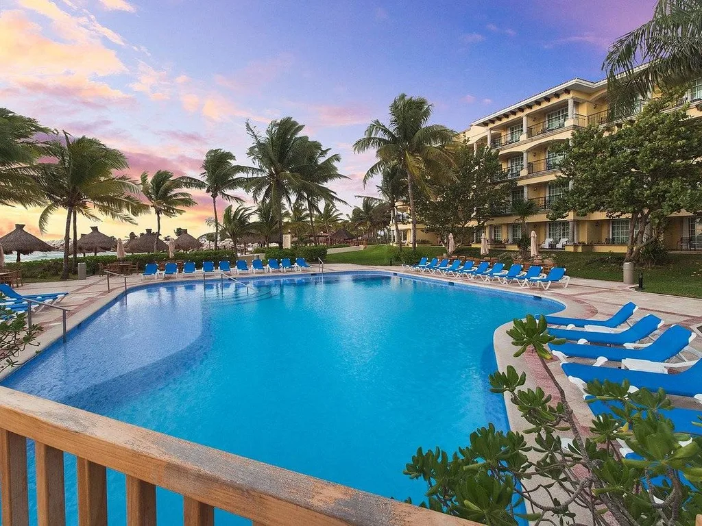 large resort pool with lots of palm trees
