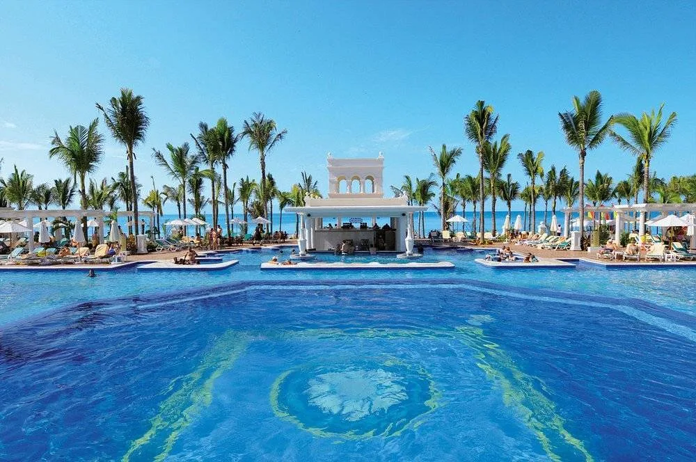 massive resort pool with palm trees
