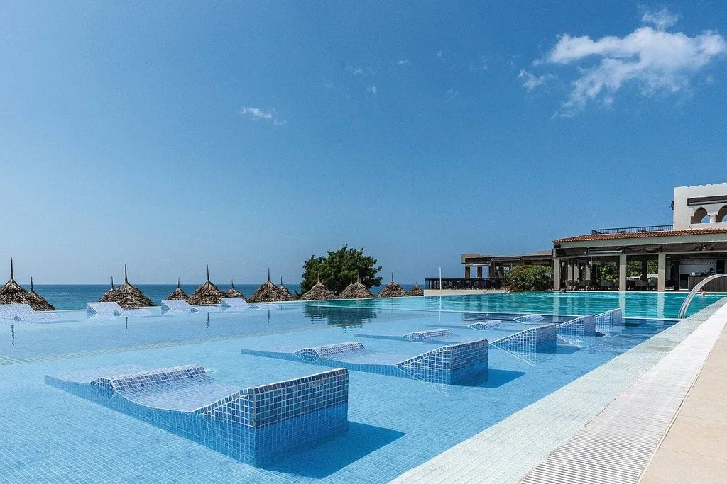 concrete lounge chairs in resort pool