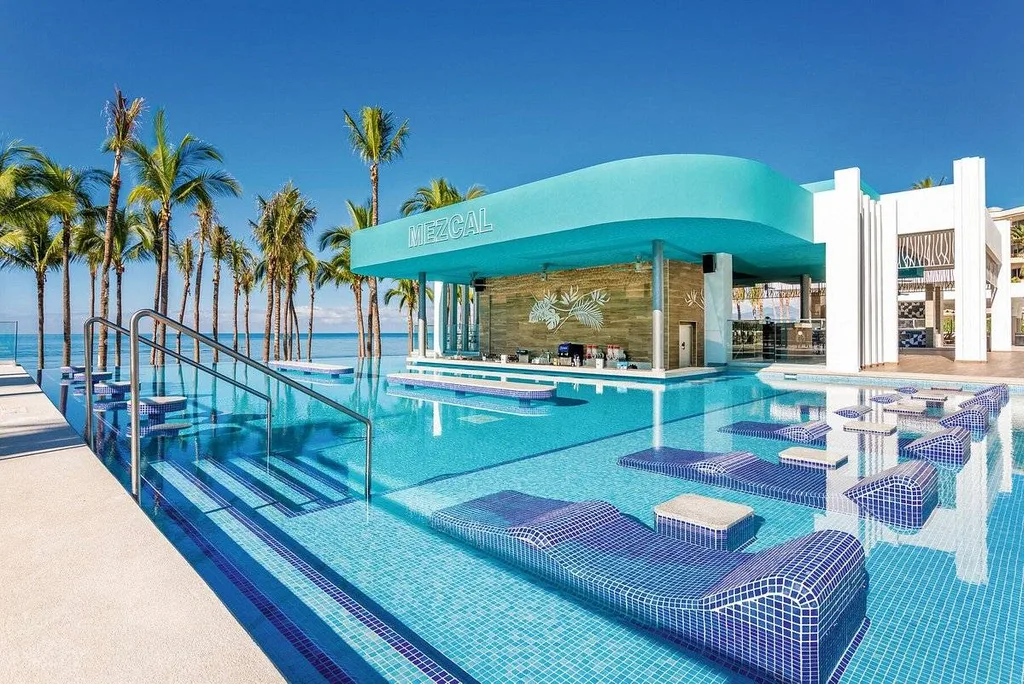 resort pool with swim-up bar and concrete lounge chairs