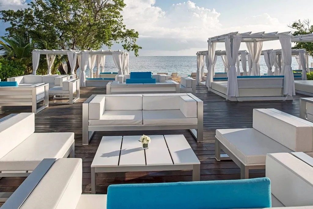multiple white lounge furniture on wooden deck