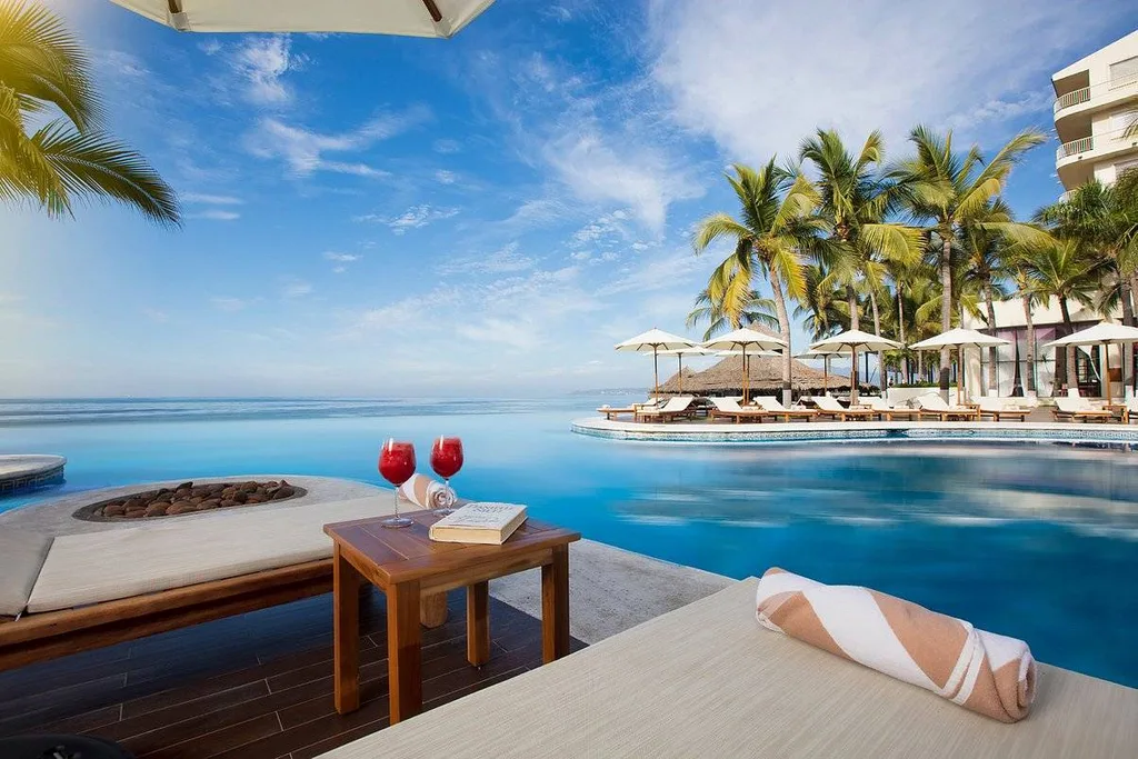 two red drinks on table in front of ocean