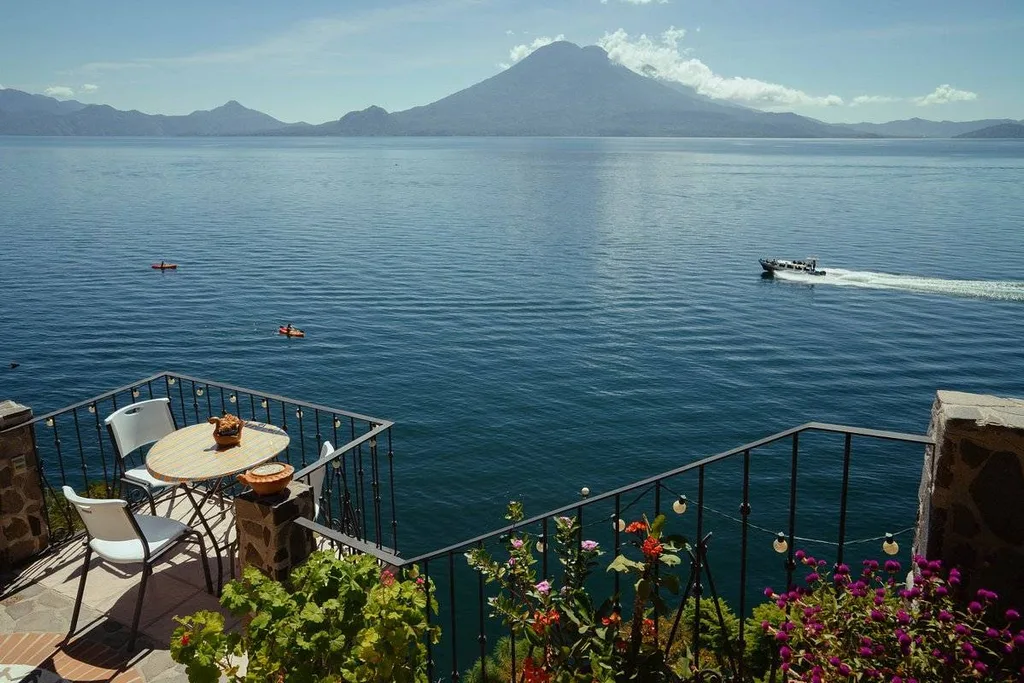 speedboat in water with mountain in background