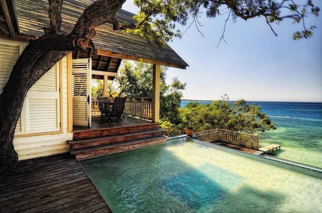 wooden resort room with infinity pool at ocean