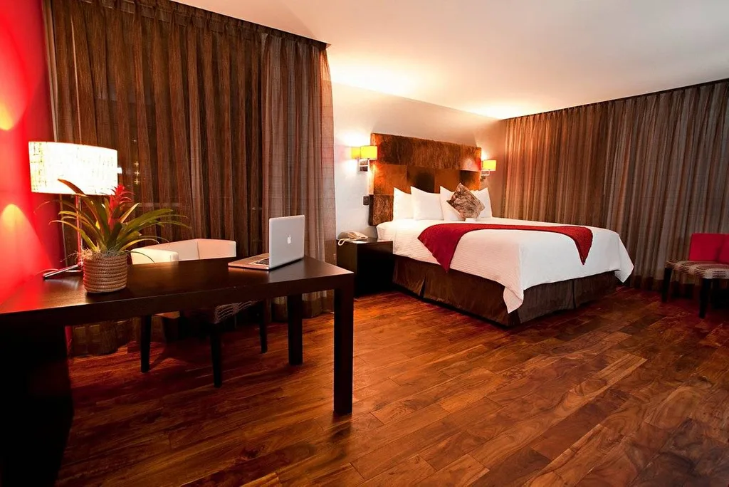 resort room with bed and wood floors