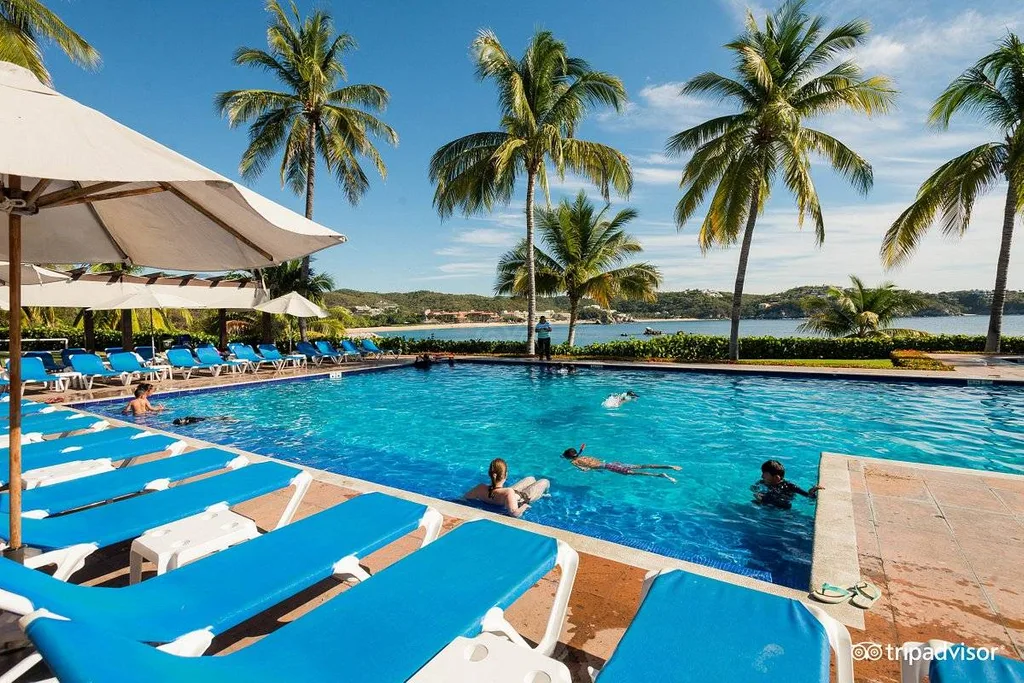 blue lounge chairs along square resort pool