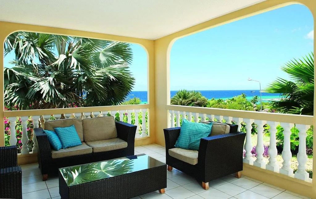 lounge furniture on porch at ocean
