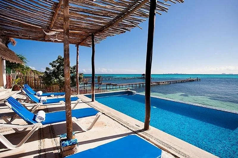 rectangle shaped pool with blue lounge chairs