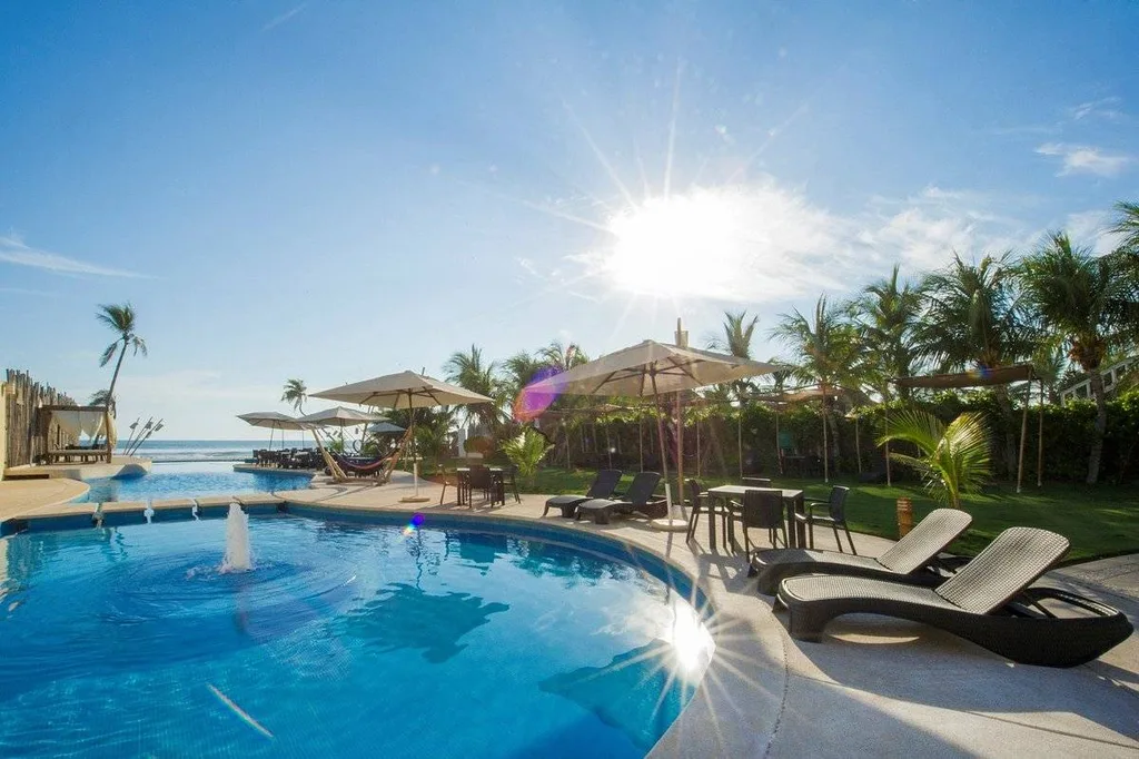 resort pool with palm trees and lounge chairs