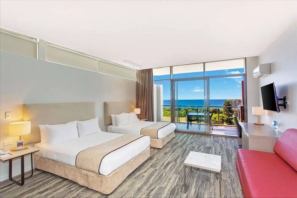 resort room with windows looking out on ocean