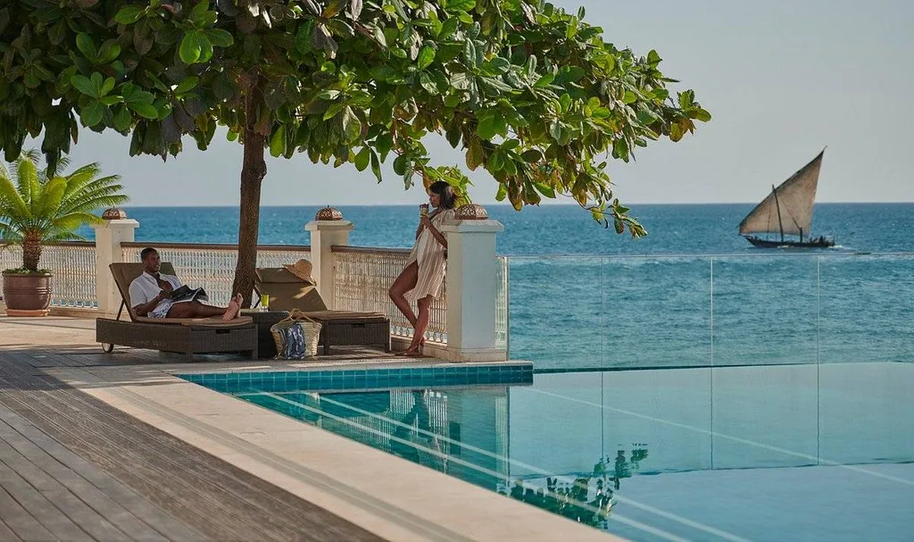 resort infinity pool with sailboat in background