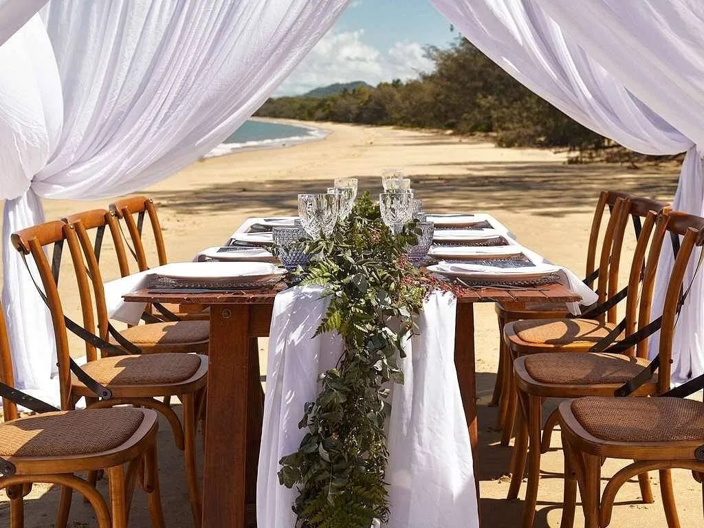 long table with chairs on the beach