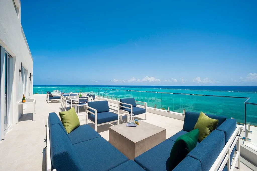 blue patio furniture next to ocean