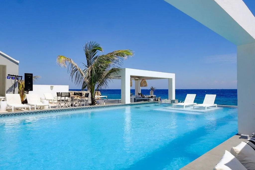 large pool at ocean with rectangle archway