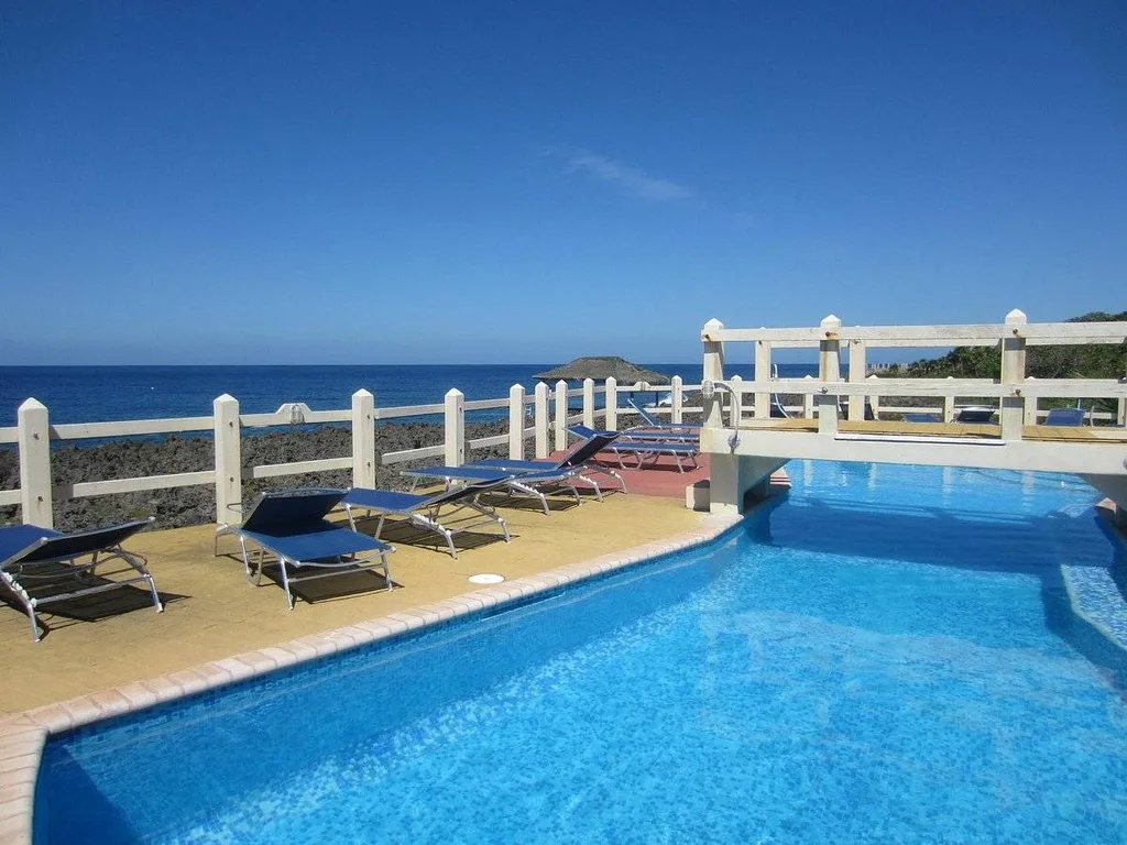 bridge over resort pool with lounge chairs