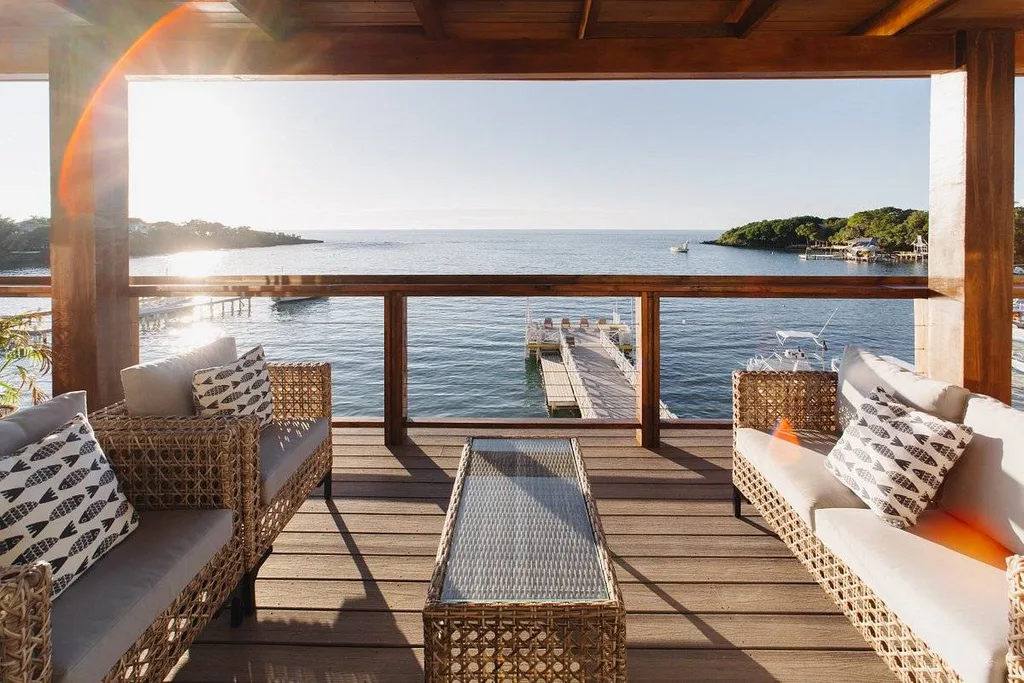 wooden deck with deck furniture at water