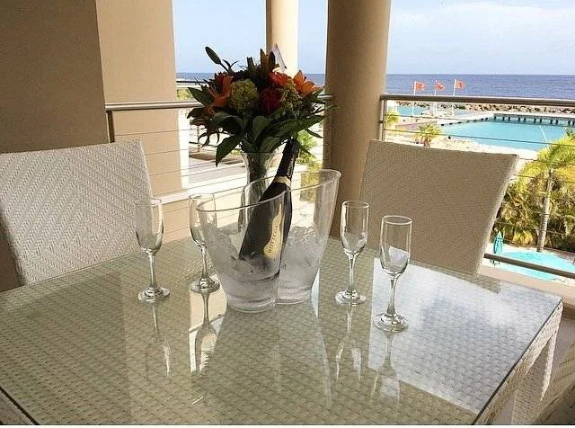 table on patio with wine and four glasses