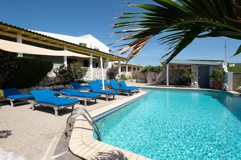 resort pools with rows of lounge chairs