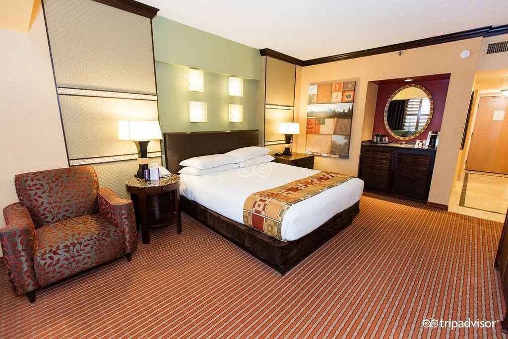 large bed and dresser with mirror in resort room