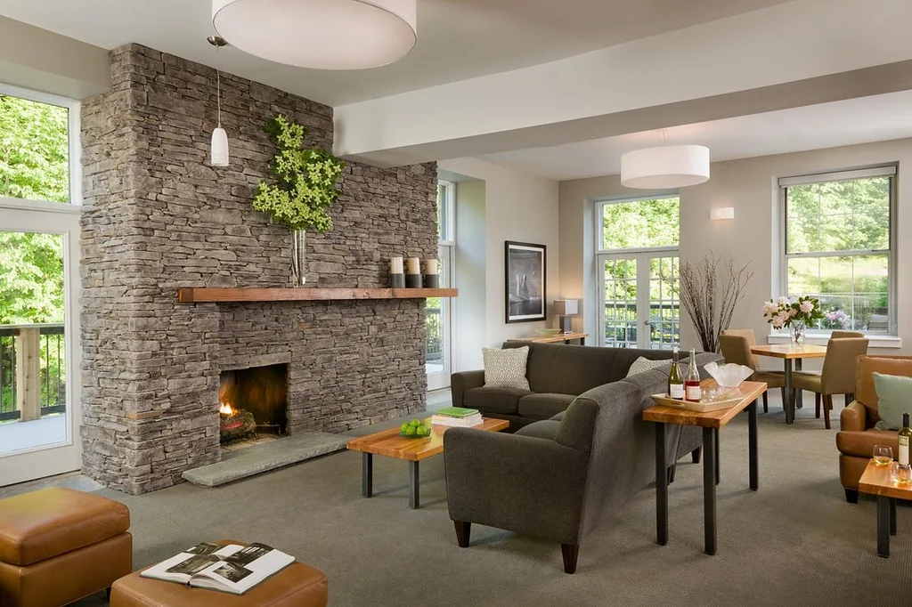 floor to ceiling stone fireplace with gray chairs
