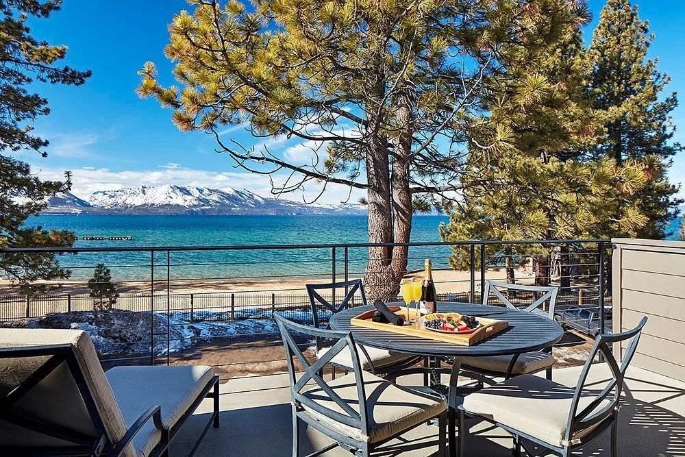 outdoor patio furniture facing lake and snow covered mountains
