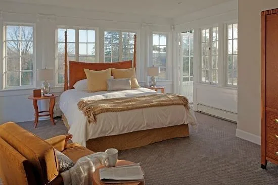 large bed with windows along every wall