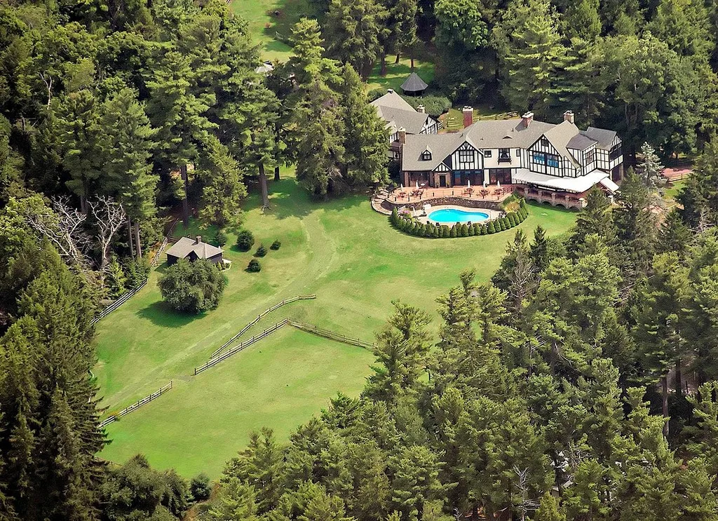 large estate with pool surrounded by trees