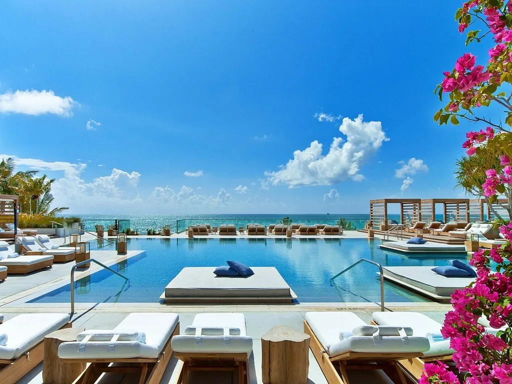 1 Hotel South Beach swimming pool lined with lounge chairs