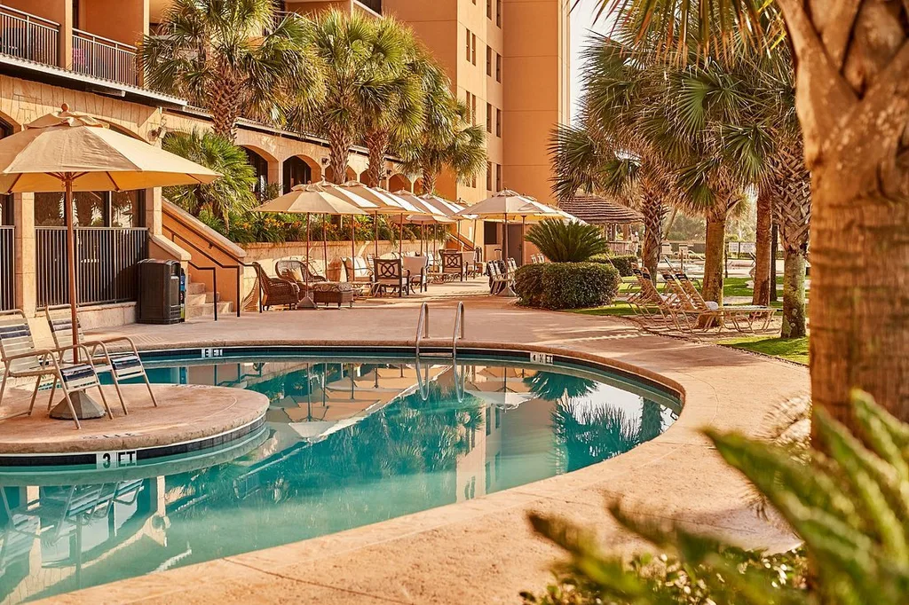 Island Vista pool with umbrellas and lounge chairs