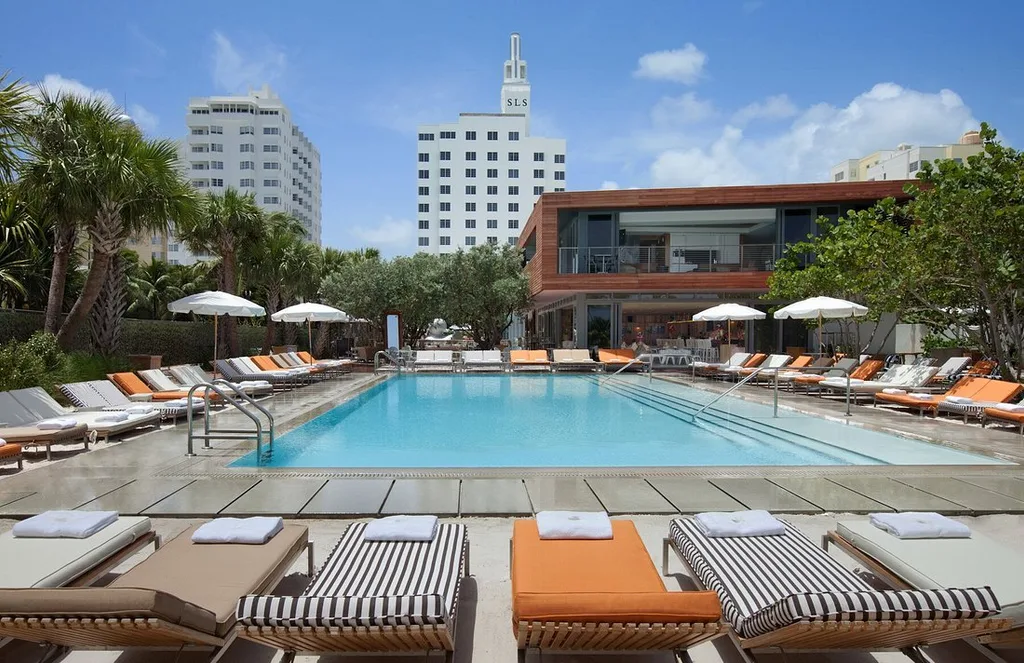 SLS South Beach pool with lounge chair and skyscraper in background