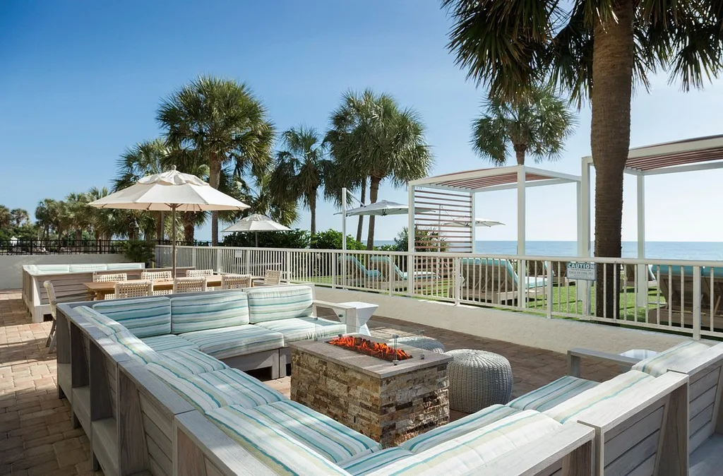 The Strand outside firepit surrounded by plush seating