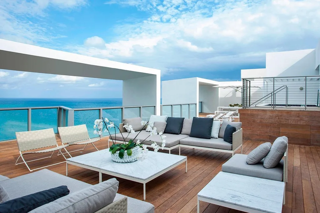 W South Beach white lounge furniture on wooden patio