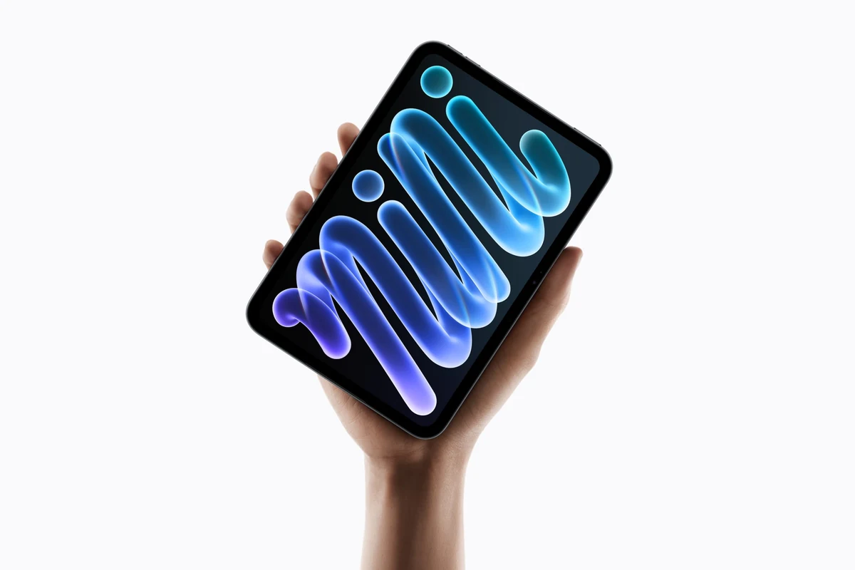 iPad mini with A20 Pro chip held in palm.